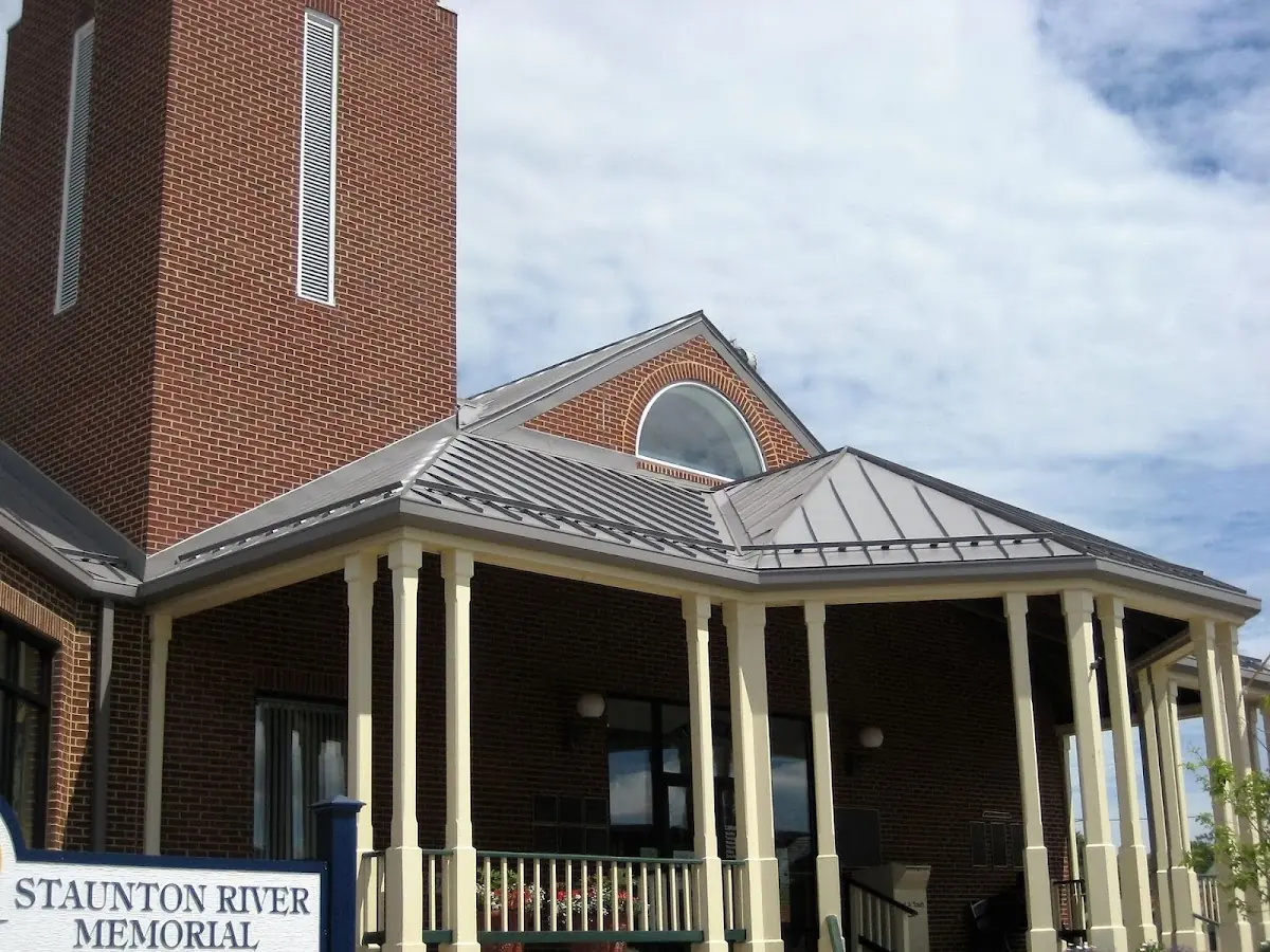 Skilled roofing craftsmen working on a residential roof in Saco